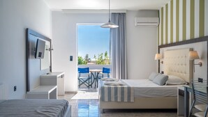 A hotel room with a bed, a desk, a chair, and a view of the outdoors. - Mythos studio 5,near beach & tavern,South Crete (Damnoni)