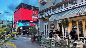 A street scene with outdoor seating at a restaurant named Bacardi. - Near airport / Isla Verde / Dinning & top attractions (Carolina)