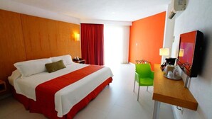 A hotel room with a large bed, a desk with a chair, a television, and a window with curtains. - Adhara Express (Cancun)