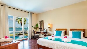 A hotel room with a bed, desk, chair, and a view of the ocean. - EAST KEYS Suite 127 Prestige: private pool, sea view, beach (Le François)