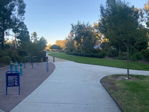 Stroll through this serene park area, featuring a winding pathway and lush greenery.