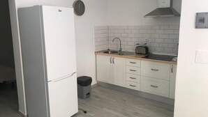 A compact kitchen with a white refrigerator, a sink, and a stove. - MAXORATA TOWN FUERTEVENTURA (Morro Jable)