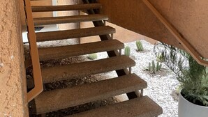 A concrete staircase with metal handrails, leading to a higher level.