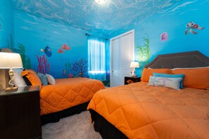 A room with two beds, a nightstand, and a wall mural of an underwater scene. - Amazing Home With Spa & Games Room In Gated Resort Close to WDW (Kissimmee)