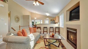 A living room with a sofa, a coffee table, a fireplace, and a ceiling fan. - 4 BED/2 BATH; Sleeps 10! CO Springs- fenced yard, pets w/fee, Great for Families (Colorado Springs)