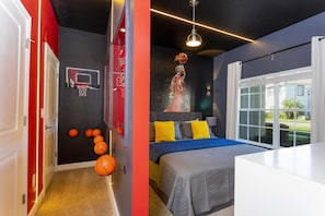 A bedroom with a bed, a basketball hoop, and a large window. - 3159- Great Family Home near Disney, private pool, Storey Lake Resort. (Kissimmee)