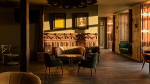 A cozy lounge area with a sofa, chairs, and a small table. - Pena D'Água Boutique Hotel & Villas  (Covilhã)