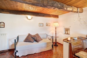 Un dormitorio con cama, lámpara, cómoda y radiador.