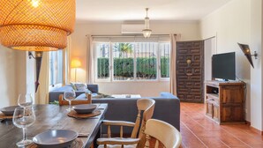 A dining area with a wooden table, chairs, and a large woven light fixture. - Villa 'Jardin Tropical' with Private Pool, Garden A/C & Wi-Fi (Manilva)