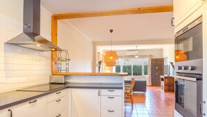 A modern kitchen with white cabinets, a stainless steel range hood, and a large oven. - Villa 'Jardin Tropical' with Private Pool, Garden A/C & Wi-Fi (Manilva)