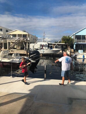 Guests can enjoy a serene marina setting with boats docked nearby, perfect for fishing and boating activities.
