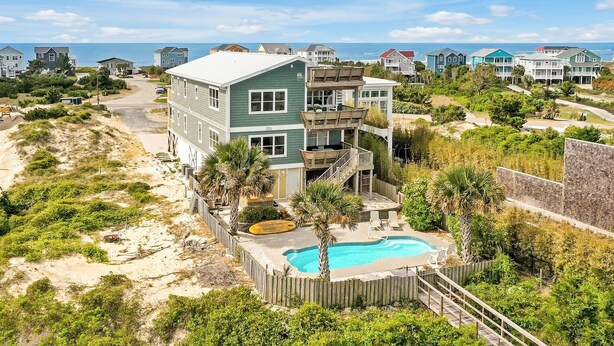 A beachfront property with a swimming pool, multiple stories, and a view of the ocean. - Bring a Boat! Oceanview/Soundfront Retreat with Gameroom/Pool/HT (Oak Island)