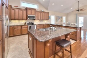 Fridge, microwave, oven, stovetop - Experience beachfront bliss at Incommunicado, a spacious 4-bedroom home in Oak Island. (Oak Island)