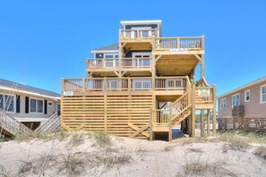 A multi-level wooden structure with a sign reading 'Sea Shack' and a number '127' visible.