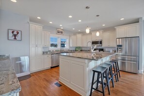 Fridge, microwave, oven, stovetop - Orange Sunset: Spacious 7-bedroom oceanfront gem in Oak Island, perfect for large groups. (Oak Island)