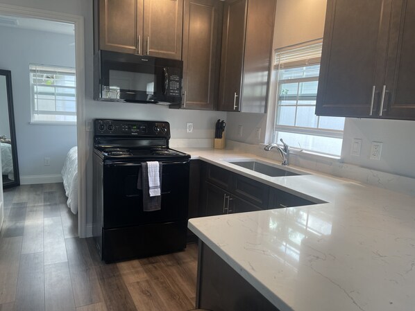 Microwave, coffee/tea maker, cookware/dishes/utensils