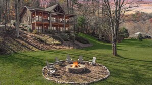 A log cabin with a fire pit surrounded by Adirondack chairs. - Toccoa Sunnyside ~ Minutes to Downtown Blue Ridge ~ Hot Tub! (Blue Ridge)