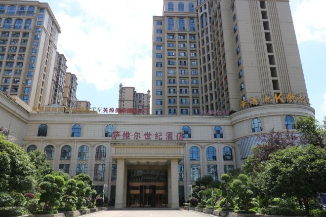 A multi-story hotel with a grand entrance, large windows, and a well-maintained exterior.