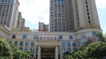 A multi-story hotel with a grand entrance, large windows, and a well-maintained exterior.