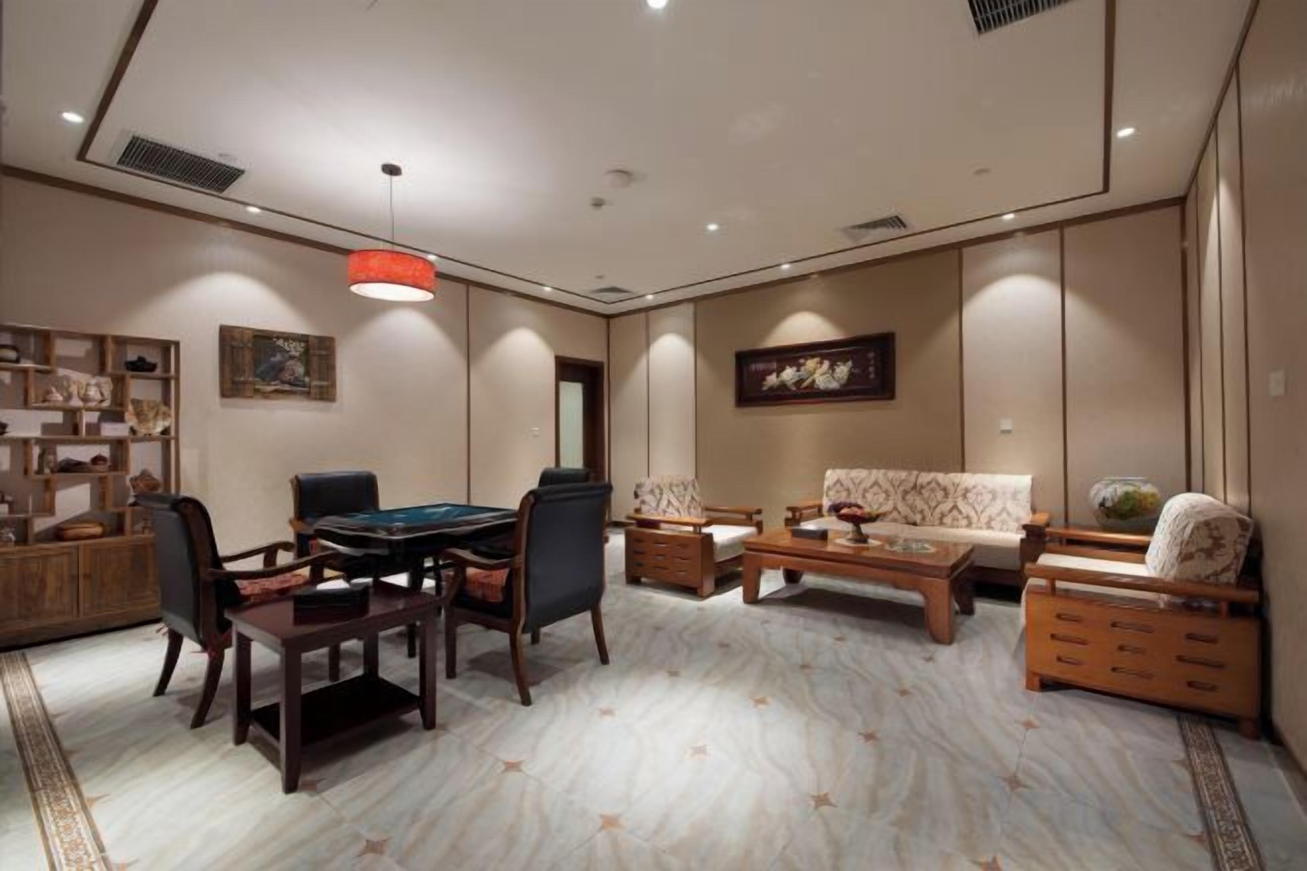 A spacious living room with a dining table, sofas, and a coffee table.