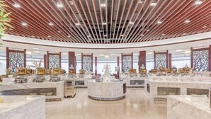 A spacious lobby with marble counters, a central decorative fountain, and a modern ceiling design. - Shenghao Seasons Hotel (Huimin)
