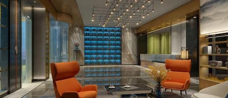 A modern lobby with a seating area, a coffee table, and a decorative vase.