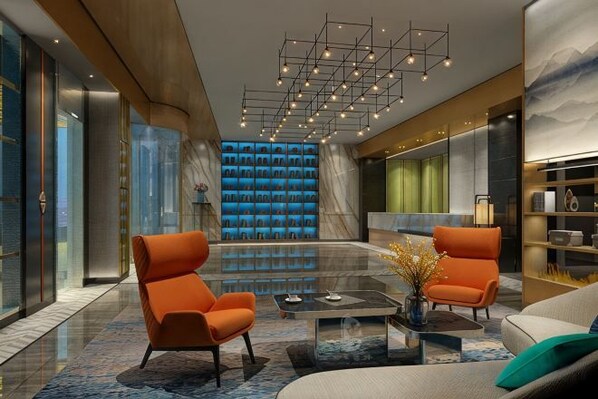 A modern lobby with a seating area, a coffee table, and a decorative vase. - Yunman Life Hotel (Xuyong)