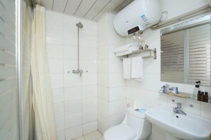 A bathroom with a shower, toilet, sink, and towel rack. - Changchun Yuanyuan Business Hotel (Jida Second Hospital Yatai Hospital Area Branch) (Changchun)