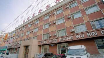 A multi-story building with signage for 'YUAN YUAN SHANG WU BIN' and 'THE BEYOND SUSHI'.