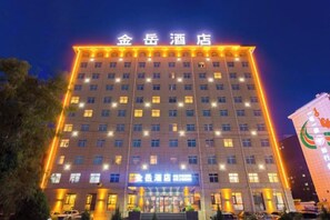 A multi-story hotel with a prominent sign at the top.
