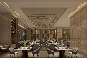 A modern restaurant interior with multiple dining tables, chairs, and a decorative ceiling. - Guohui Hotel (Minhou Ganzhe) (Minhou)