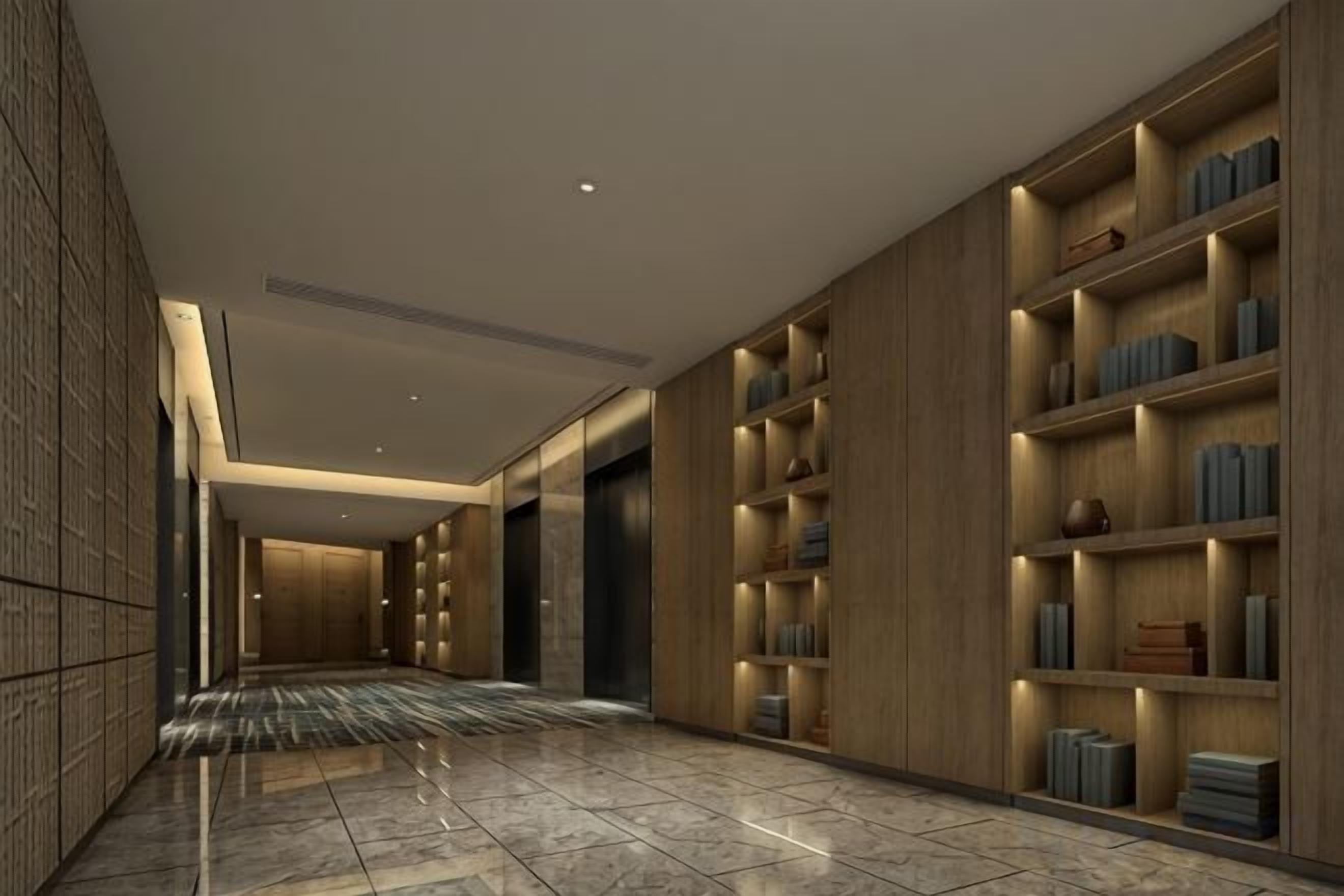 Een gang met houten boekenkasten, een betegelde vloer en een modern plafondontwerp.