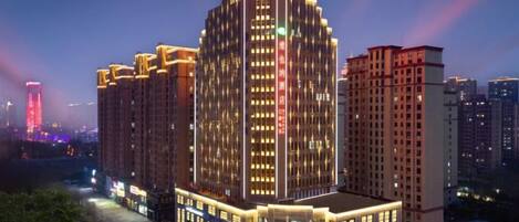A multi-story hotel with a prominent entrance and signage.