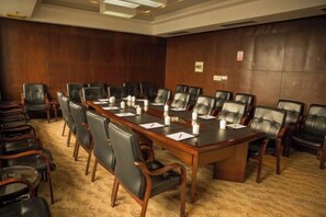 A conference room with a long table, multiple chairs, and a carpeted floor. - Mingzhao Hot Spring International Hotel (Wuyi)