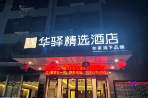 A hotel sign with illuminated text and a contact number. - Haiyue Junlan Hotel (Huangshan City)