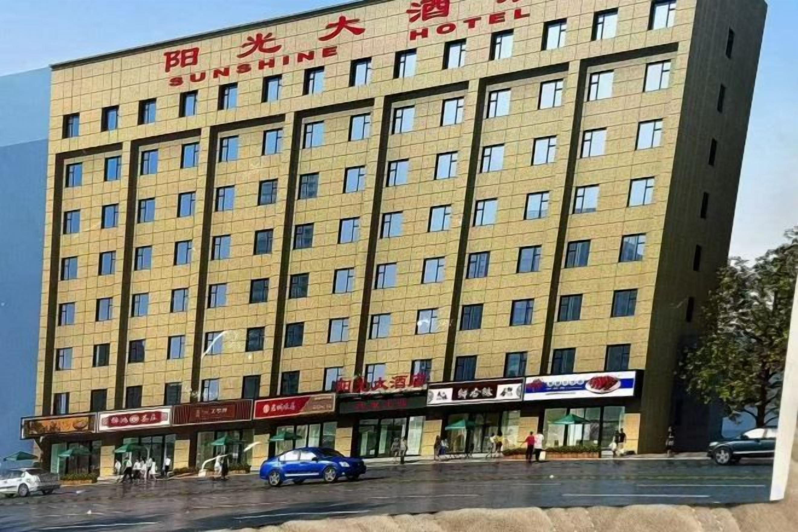 A multi-story building with a sign reading 'Sunshine Hotel.'