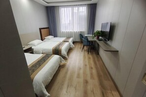 A hotel room with two beds, a desk with a chair, a TV, and a window with curtains. - Sunshine Hotel (Yuncheng Wanda Plaza Central Hospital) (Yuncheng)
