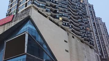 A high-rise building with a unique architectural design, featuring a series of balconies and a prominent glass facade.