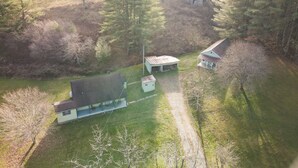An aerial view of a rural property with a main house, a smaller building, and a silo. - New River Cottage (Crumpler)