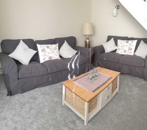 Relax in this inviting living space with a comfortable sofa, coffee table, and floor lamp.
