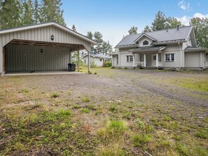 A two-story house with a covered garage and a front porch. - Tyssinniemi by Interhome (Punkaharju)