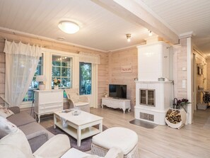 A cozy living room with a fireplace, a television, and comfortable seating.