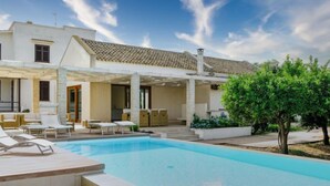 A modern house with a swimming pool, outdoor seating, and a covered patio area. - Barbara by Interhome (Marsala)
