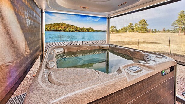 A hot tub with a view of a lake and a wooden deck. - Idyllic Florissant Cabin w/ Patio & Hot Tub! (Florissant)
