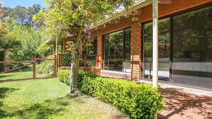 A modern house with large windows, a brick exterior, and a well-maintained garden. - Haus on Houghs : Space and style in Bright (Bright)