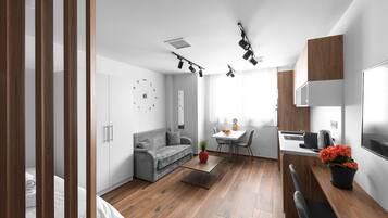 Deluxe Studio, Kitchen | Living area | Flat-screen TV