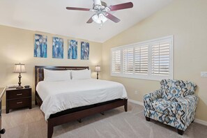 A bedroom with a bed, nightstands, a chair, a ceiling fan, and wall art. - Painted Mountain Golf Retreat /On Golf Course/Private Heated Pool (Mesa)