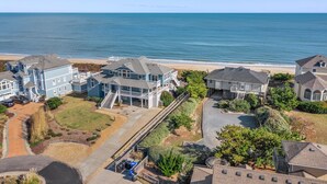 A coastal residential area with houses, a beach, and a clear view of the ocean. - Ducktopia: 6-minute walk to Beach, Pool, Hot Tub, Short Walk to Downtown Duck (Duck)