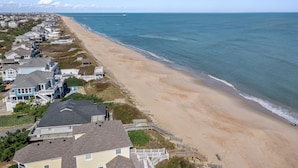 A coastal residential area with houses along the beach, a wooden walkway, and a view of the ocean. - Ducktopia: 6-minute walk to Beach, Pool, Hot Tub, Short Walk to Downtown Duck (Duck)