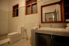 Ein Badezimmer mit Toilette, Waschbecken und Spiegel.